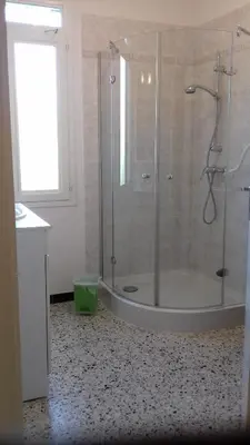 a bathroom with a shower with a glass door at A 5 Minutes des Ocres Gïte La Charite Gordes Roussillon in Gargas