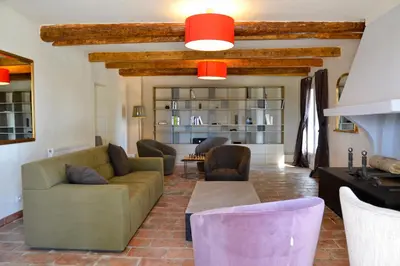 a living room with a couch and chairs and a table at Mas Le 7 in Saint-Andiol