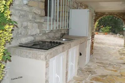 a kitchen with a sink and a refrigerator at Le Mas des Chênes in Rognes