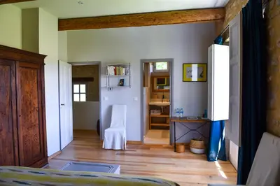 a bedroom with a bed and a room with a hallway at Le Mas de la Sorgue in Le Thor