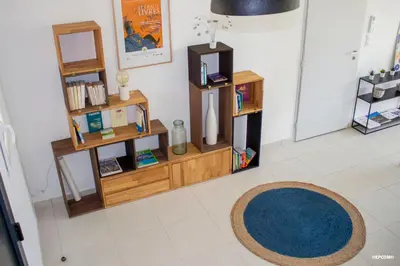 a room with book shelves and a rug on the floor at BASTIDE 7 in La Fare-les-Oliviers