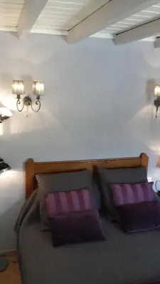 a bedroom with a bed with two pillows at Mas Dansavan Chambres d'hôtes in Oppède