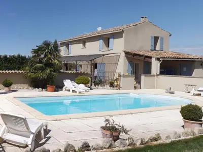 a swimming pool in front of a house at Demeure d'hôtes et Mas Maurice in Oppède