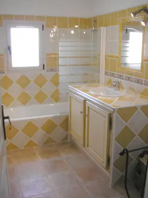 a bathroom with a tub and a sink and a bath tubermottermott at Demeure d'hôtes et Mas Maurice in Oppède