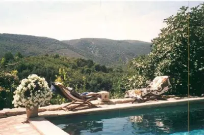 a swimming pool with a view of a mountain at La Source à Bonnieux en Luberon in Bonnieux