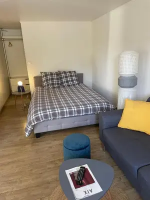 a living room with a bed and a couch at T2 de la Bastide Rouge vue exceptionnelle (180°) sur Aix domaine privé T2 indépendant de 37 m2 avec terrasse exposée plein sud Piscine 10 X 5 in Aix-en-Provence