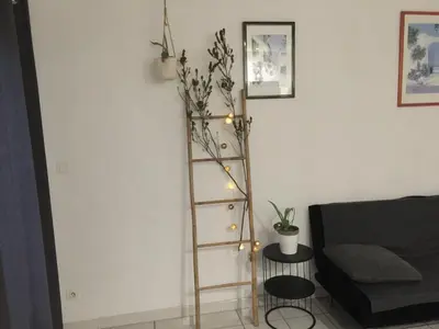 a living room with a ladder with lights and a couch at T2 avec TERRASSE, CLIM , box fibre in Vedène