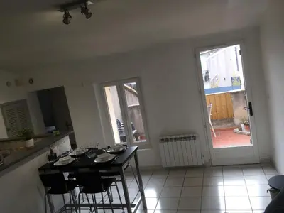 a kitchen with a table and chairs in a room at T2 avec TERRASSE, CLIM , box fibre in Vedène