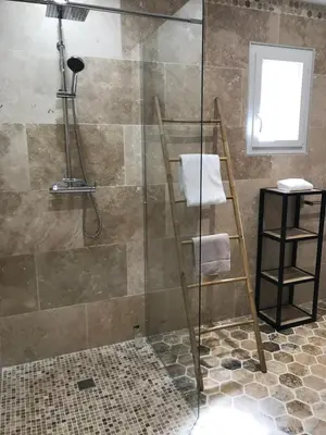 a bathroom with a shower with a glass door at Le Devem De Mirapier in Cornillon-Confoux