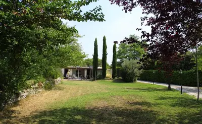 a house in a park with trees and a yard at Gîte et maison de vacances Campagne Valérie in Aix-en-Provence