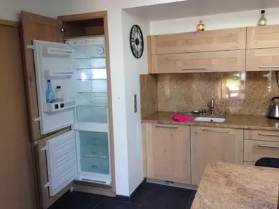 a kitchen with an open refrigerator and a sink at Gîte et maison de vacances Campagne Valérie in Aix-en-Provence