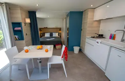 a bedroom with two beds and a window at Camping Les Hautes Prairies in Lourmarin