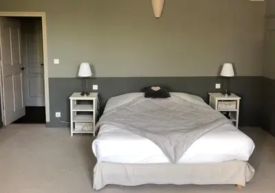 a bedroom with a large bed with two night stands at MAISON LUBERON in Apt