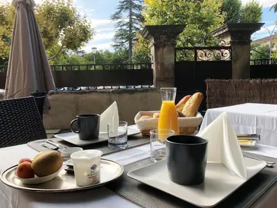 a table with plates of food and drinks on it at MAISON LUBERON in Apt
