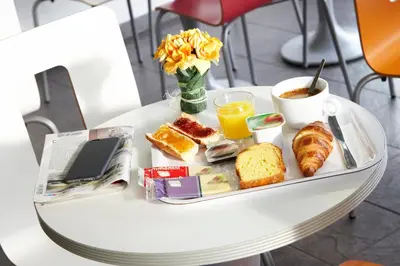 a tray of breakfast foods and coffee on a table at Premiere Classe Avignon Parc Des Expositions in Montfavet