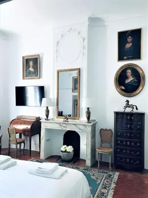 a bedroom with a fireplace and a mirror at Château de Saint-Girons - Luxury Guest House in Provence in Aix-en-Provence