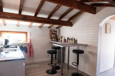 a kitchen with a counter and stools in a room at Suite l'Escoundudo in Aix-en-Provence