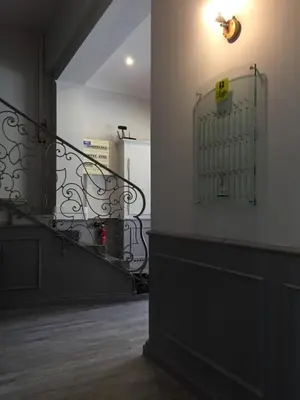 a staircase with a metal gate in a room at Hotel du Midi in Salon-de-Provence