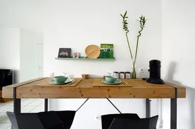 a wooden table with two cups on top of it at T2 cosy proche du centre-ville avec garage inclus in Aix-en-Provence