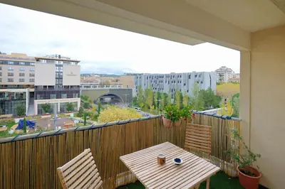 a balcony with a table and two chairs on a balcony at T2 cosy proche du centre-ville avec garage inclus in Aix-en-Provence
