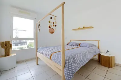 a bedroom with a bed with a wooden frame at T2 cosy proche du centre-ville avec garage inclus in Aix-en-Provence