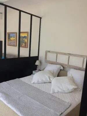 a bedroom with two white pillows on a bed at L'ATELIER JONQUERETTES in Jonquerettes