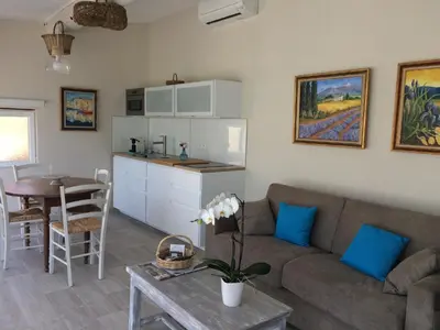 a living room with a couch and a table at L'ATELIER JONQUERETTES in Jonquerettes
