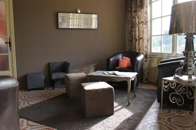 a living room with two chairs and a table at Logis Hôtel Le Manoir - Luberon in Apt