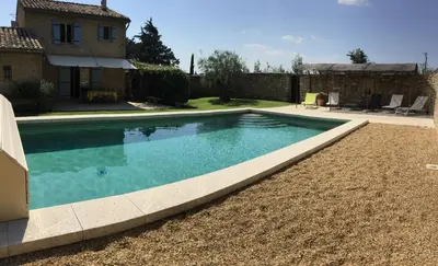 a swimming pool in the yard of a house at typical provencal bastide, built of local stones, in the luberon in cheval-blanc with secured pool and wifi -sleeps 6 people. in Cheval-Blanc