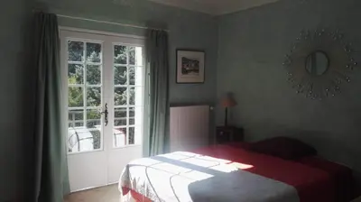 a bedroom with a bed and a window at Le Samaro in Puyvert