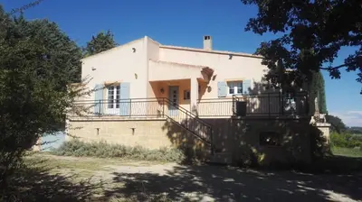 a large white house with a staircase in front of it at Le Samaro in Puyvert