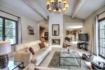 a living room with a couch and a fireplace at Mas Santoline in Eygalières