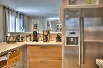 a kitchen with a stainless steel refrigerator at Mas Santoline in Eygalières