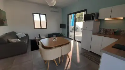 a kitchen with a table in the middle of a room at Villa Quatra aux portes d'Aix-en-Provence in Éguilles