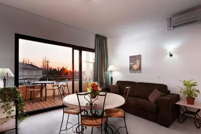 a living room with a couch and a table at Lagrange Vacances L’Oustau de Sorgue in LʼIsle-sur-la-Sorgue