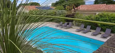 a pool with chairs next to a house at Les dentelles Évasion Provençale Villa avec Piscine et jardin in Carpentras