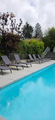 a row of lounge chairs next to a swimming pool at Les dentelles Évasion Provençale Villa avec Piscine et jardin in Carpentras