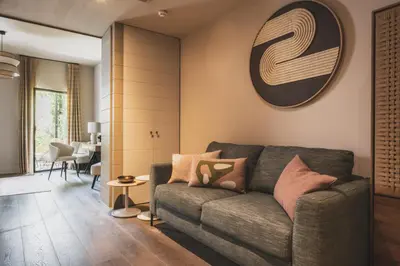 a living room with a couch and a table at Les Lodges Sainte-Victoire Hotel & Spa in Aix-en-Provence