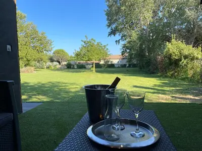 a tray with two wine glasses on a table at DEPENDANCE PRIVEE - HALTE ROUTE in Le Thor