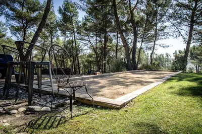 a playground in a park with trees and grass at Mas lou Félibrige in Venelles