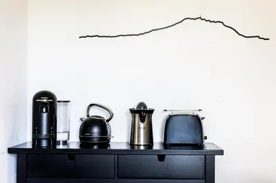 a black table with kettle and coffee makers on it at Mas lou Félibrige in Venelles