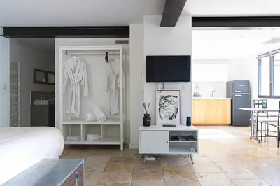 a bedroom with a bed and a room with a closet at Mas lou Félibrige in Venelles