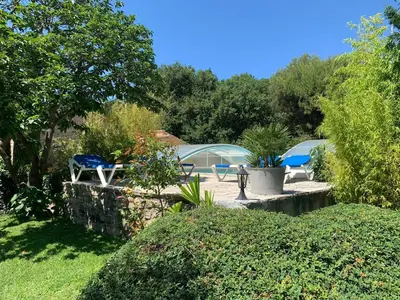 a garden with two chairs and a tent at Bastide Sainte Agnès in Carpentras