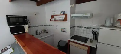 a small kitchen with a sink and a microwave at Gîte les Cyprès (Bastide Sainte Agnès) in Carpentras