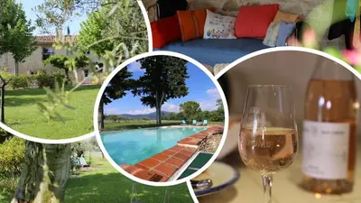 a table with a glass of wine and a wine bottle at DOMAINE de MAS CARON Gîte 4* au pied du Ventoux en Provence in Caromb