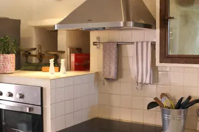 a kitchen with a sink and a stove top oven at DOMAINE de MAS CARON Gîte 4* au pied du Ventoux en Provence in Caromb