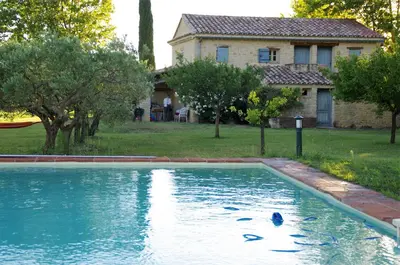 a swimming pool in front of a house at DOMAINE de MAS CARON Gîte 4* au pied du Ventoux en Provence in Caromb