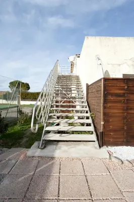 a metal staircase leading up to a building at Gîte du Charme Provençal in Sénas