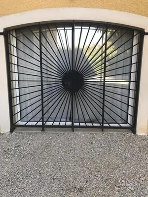 a metal gate with a window on a building at Une Pause Douceur - Suite Orchidée in Eyguières