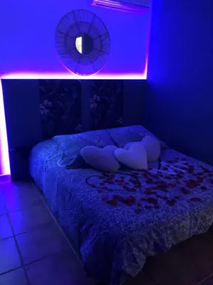 a bedroom with a bed with a blue light at Une Pause Douceur - Suite Orchidée in Eyguières